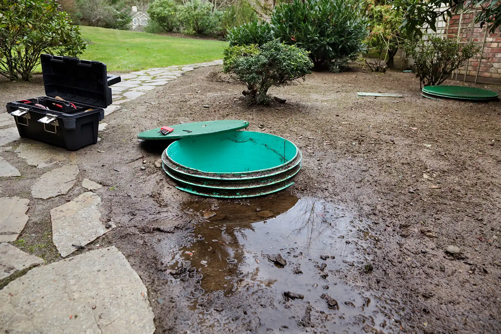 Septic tank pump chamber with the lid off in the ground