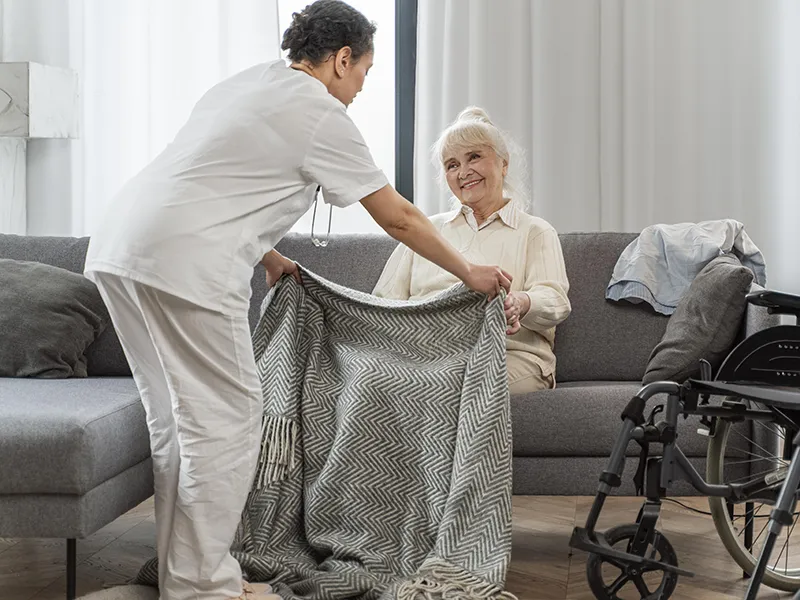 A nurse taking care of a senior woman in a nursing home