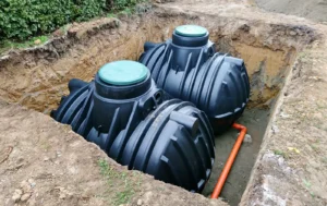 Two septic tanks being installed in the ground